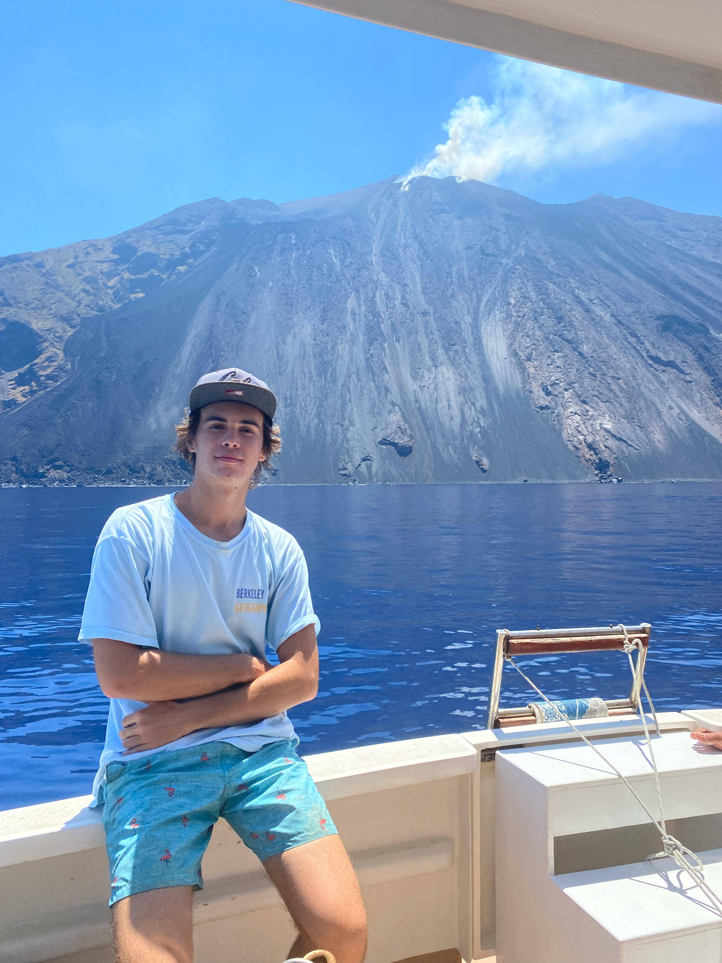 a student studying abroad in Sicily posing in front of a volcano